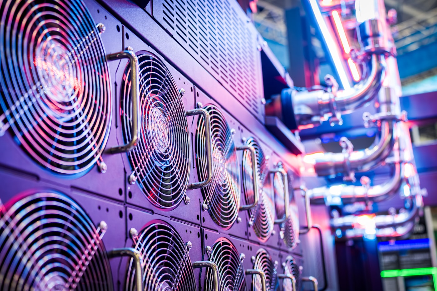 Rows of illuminated data center server racks with cooling fans