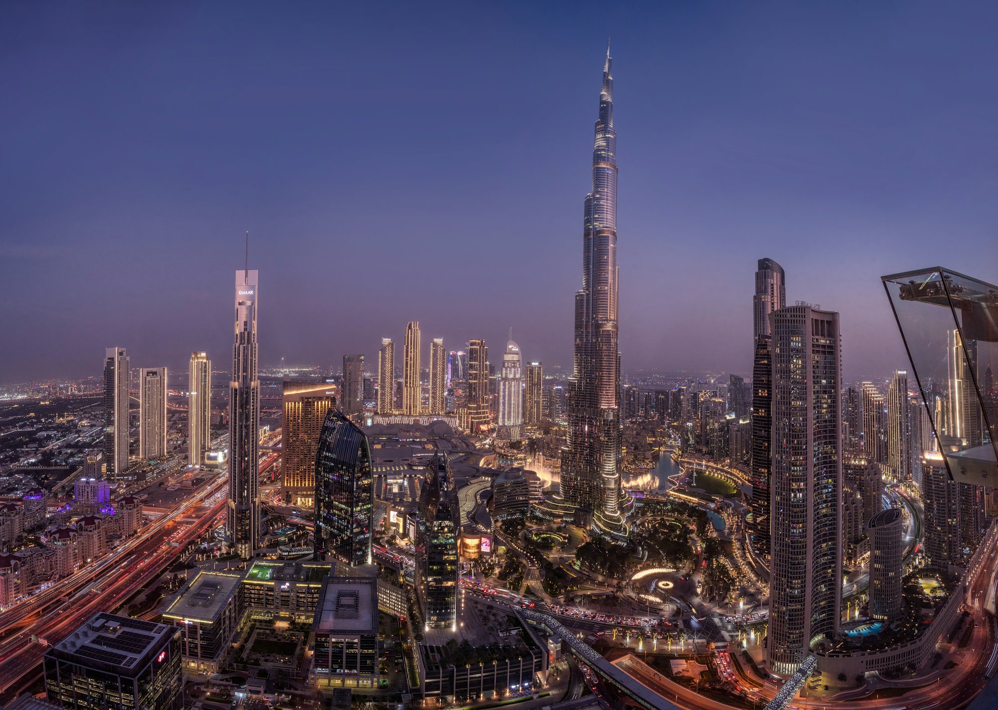 Downtown Dubai skyline at dusk, with the Burj Khalifa illuminated