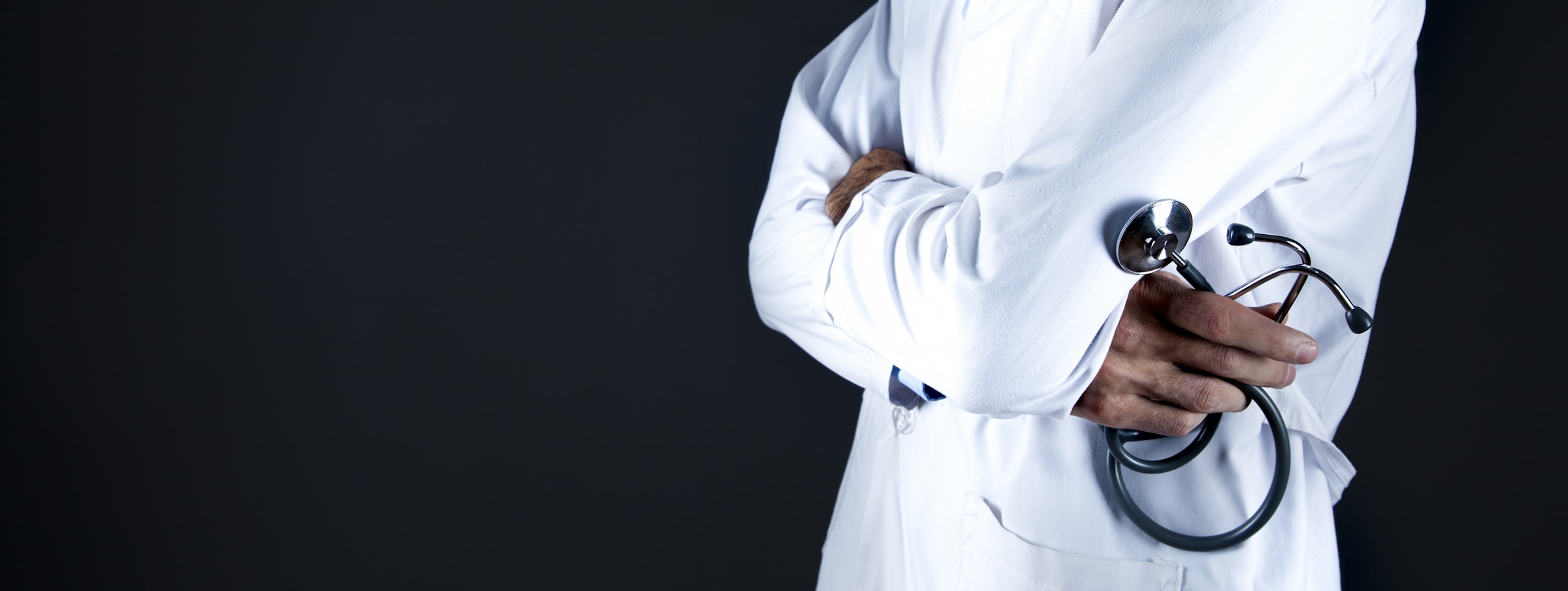 A doctor in a white coat holding a stethoscope