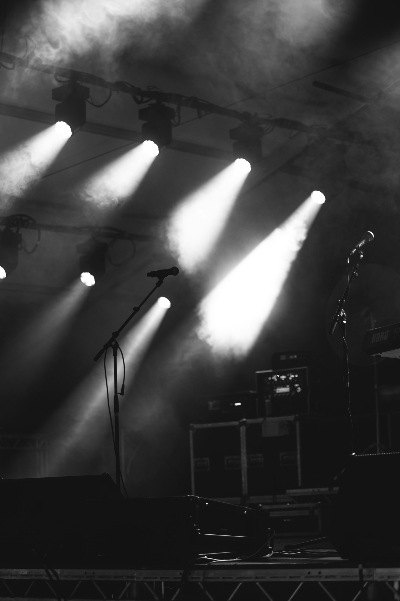 Silhouette of a microphone stand under dramatic stage lights